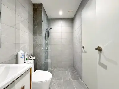 a bathroom with a toilet and a shower at Majestic Calm 1BR Suite with Rooftop Infinity Pool in Kuala Lumpur