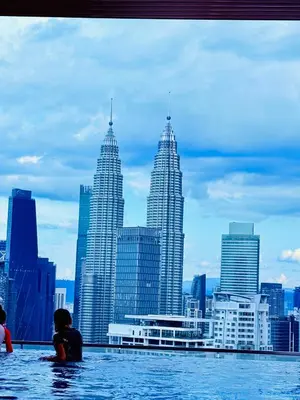 a group of people swimming in the water in the city at THE Colony KL at Sky World in Kuala Lumpur