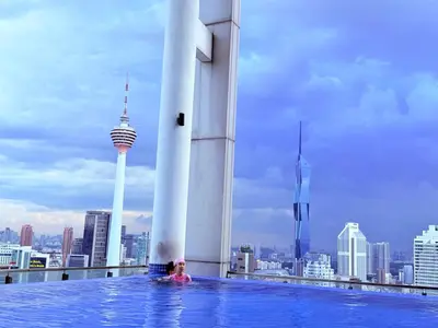 a woman in a swimming pool on top of a building at THE Colony KL at Sky World in Kuala Lumpur