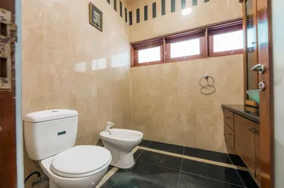 a bathroom with a toilet and a sink at Provence Chateau Retreat 40 Pax Pool Villa Bangsar by Verano in Kuala Lumpur