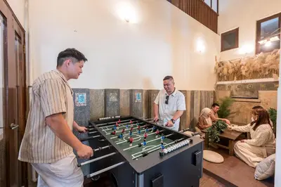a group of men playing a game of foosball at Provence Chateau Retreat 40 Pax Pool Villa Bangsar by Verano in Kuala Lumpur