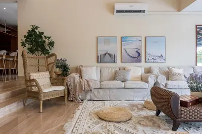 a living room with a white couch and chairs at Provence Chateau Retreat 40 Pax Pool Villa Bangsar by Verano in Kuala Lumpur