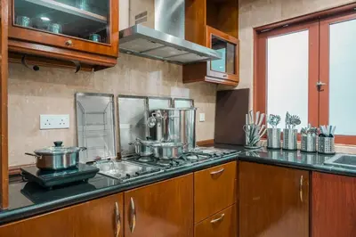 a kitchen with pots and pans on a stove at Provence Chateau Retreat 40 Pax Pool Villa Bangsar by Verano in Kuala Lumpur