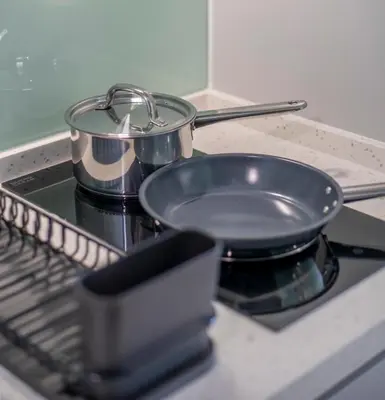 a frying pan sitting on top of a stove at Riveria Sky Residences KL Sentral with Infinity Pool in Kuala Lumpur