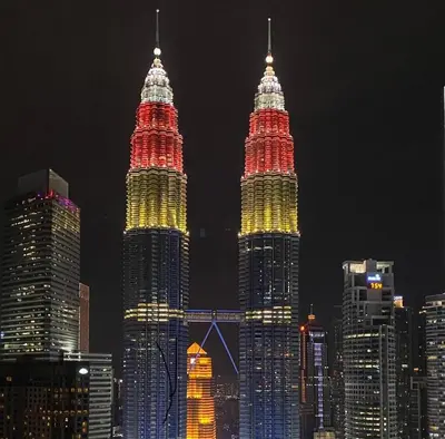 a view of the petronas twin towers at night at Nour Homestay KLCC View - COZY 1 in Kuala Lumpur