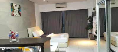 a living room with a couch and a table in a room at Summer suite KLCC by Classic Stay in Kuala Lumpur