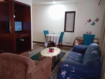 a living room with two couches and a table at Maritime Residence at Times Square KL in Kuala Lumpur