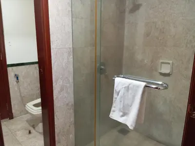 a bathroom with a glass shower stall with a towel at Maritime Residence at Times Square KL in Kuala Lumpur