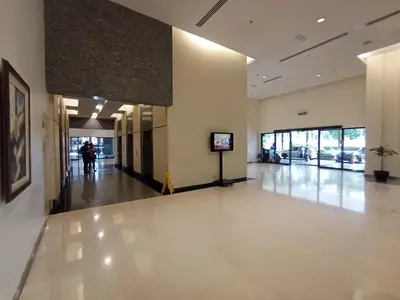 a hallway of a building with a person walking down it at Maritime Residence at Times Square KL in Kuala Lumpur