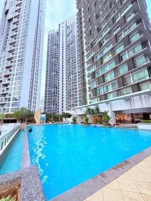 a large swimming pool in front of tall buildings at Cozyhome suites Swiss Garden Residance in Kuala Lumpur