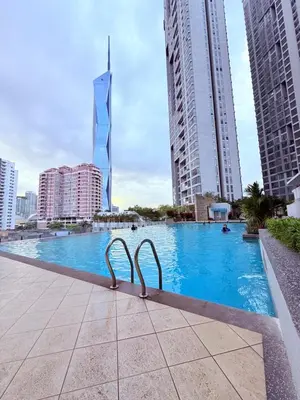 a swimming pool in a city with tall buildings at Cozyhome suites Swiss Garden Residance in Kuala Lumpur
