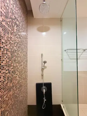 a shower in a bathroom with a glass wall at Cozyhome suites Swiss Garden Residance in Kuala Lumpur