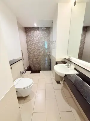 a bathroom with a toilet and a sink and a shower at Cozyhome suites Swiss Garden Residance in Kuala Lumpur