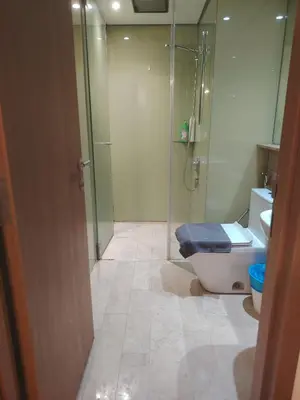 a bathroom with a glass shower and a toilet at Sky Suites Apartment service in Kuala Lumpur