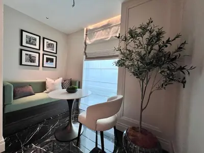 a living room with a table and a potted plant at Apartment Sixceylon City Centre in Kuala Lumpur