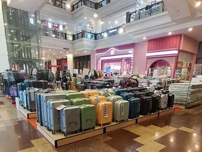a store filled with lots of different types of luggage at Time square luxury suites in Kuala Lumpur