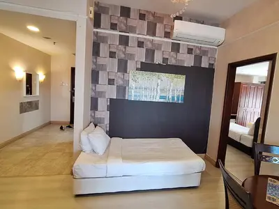 a bedroom with a large white bed in a room at Time square luxury suites in Kuala Lumpur