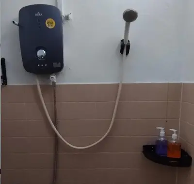 a bathroom with a hose hooked up to a shower at Segambut Homestay MITEC KLCC PWTC town center in Kuala Lumpur