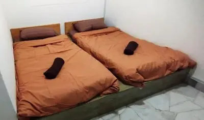 two beds sitting next to each other in a room at Segambut Homestay MITEC KLCC PWTC town center in Kuala Lumpur