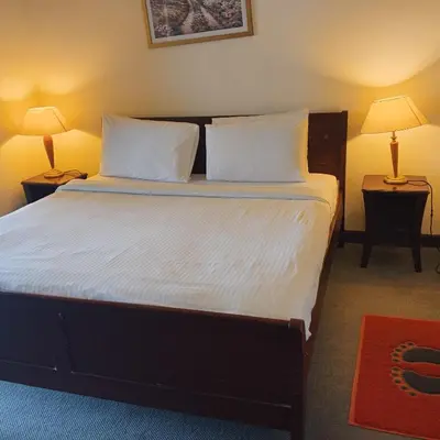 a bedroom with a large bed with white sheets and pillows at Home land apartment by Times Square in Kuala Lumpur