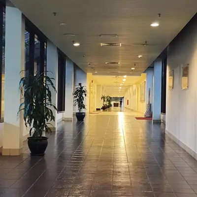 an empty hallway in a building with potted plants at Home land apartment by Times Square in Kuala Lumpur