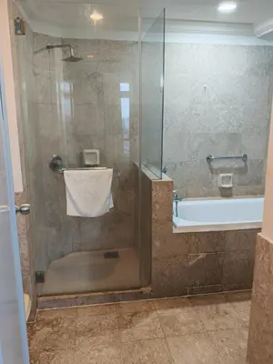 a bathroom with a shower and a tub and a sink at Home land apartment by Times Square in Kuala Lumpur