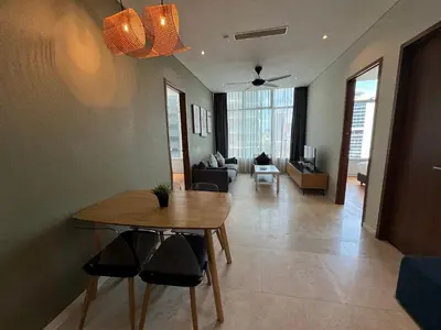 a living room with a table and a couch at Tomato Homestay in Kuala Lumpur