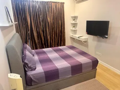 a small room with a bed and a tv at Desa green unit in Kuala Lumpur