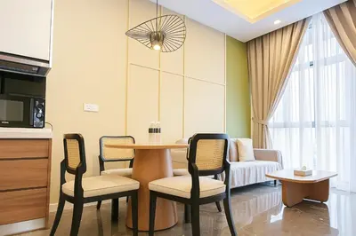 a living room with a table and chairs and a couch at Royce Residence KLCC twin tower by ABM Unique in Kuala Lumpur