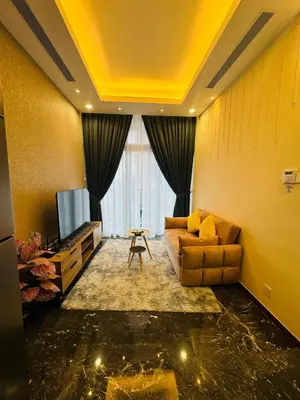 a living room with a couch and a television at Royce Residence KLCC twin tower by ABM Unique in Kuala Lumpur