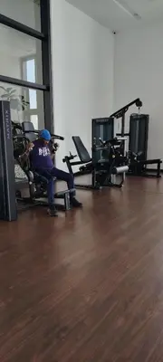 a person sitting on a chair in a gym at Chambers suites KLCC by Infinity in Kuala Lumpur
