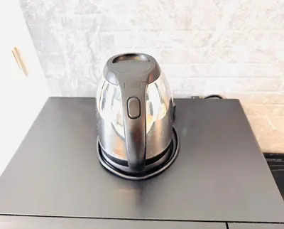 a tea kettle sitting on top of a table at Robertson Residence by Aspire Suites in Kuala Lumpur