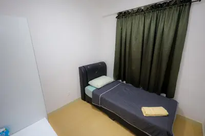 a small bed in a room with a window at M Arisa KL City View by AT in Kuala Lumpur