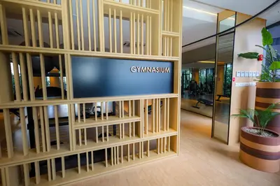 an office lobby with a tv in a wooden entertainment center at M Arisa KL City View by AT in Kuala Lumpur