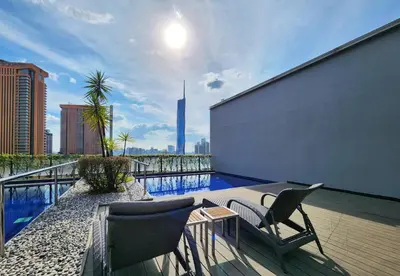 a balcony with chairs and a swimming pool on a building at Bukit Bintang Fairlane Residence #1810 Kuala Lumpur in Kuala Lumpur