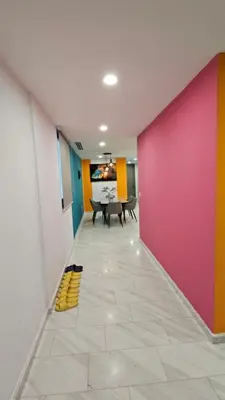a dining room with a pink and colorful wall at Crystal Exclusive Suites KLCC in Kuala Lumpur