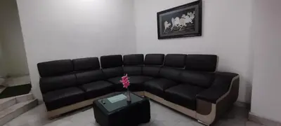 a black couch in a living room with a vase at Segambut House near MITEC KLCC PWTC 14 paxs in Kuala Lumpur