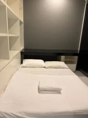 a bed with white sheets and a towel on it at Platinum kuala lumpur by Bright Suites in Kuala Lumpur
