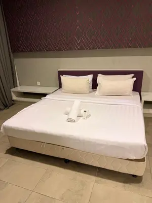 a large white bed with two towels on it at Platinum kuala lumpur by Bright Suites in Kuala Lumpur