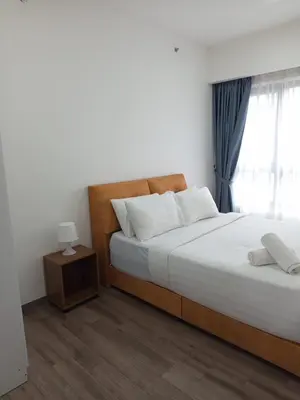 a bedroom with a large bed and a window at KL Residence By Agile Suites in Kuala Lumpur