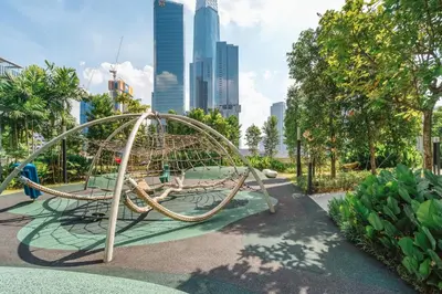a playground in a park with a city in the background at Deluxe 2BR Agile Bukit Bintang by RumaBnB in Kuala Lumpur