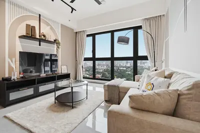 a living room with a couch and a tv at Deluxe 2BR Agile Bukit Bintang by RumaBnB in Kuala Lumpur