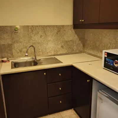 a kitchen with a sink and a counter top at Home World Apartment At Times Square in Kuala Lumpur