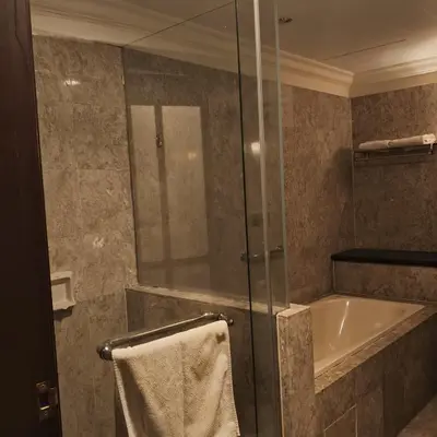 a bathroom with a shower and a bath tub at Home World Apartment At Times Square in Kuala Lumpur