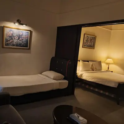 a hotel room with two beds and a mirror at Home World Apartment At Times Square in Kuala Lumpur