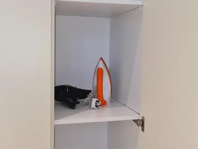 a shelf with a mirror and a pair of shoes at Home For Traveler At Majestic Residence in Kuala Lumpur