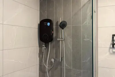 a shower with a phone on the wall at KLCC Majestic Residence By Vglory Home in Kuala Lumpur