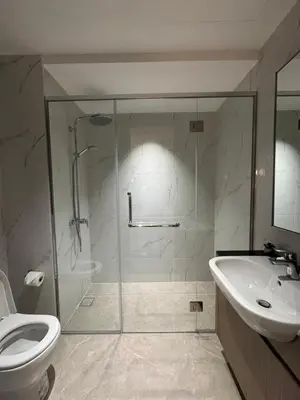 a bathroom with a shower and a toilet and a sink at KLCC View Suites By Agile in Kuala Lumpur