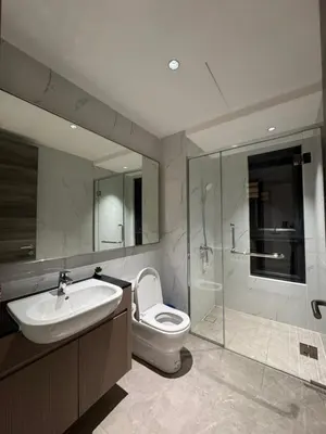a bathroom with a toilet and a sink and a shower at KLCC View Suites By Agile in Kuala Lumpur