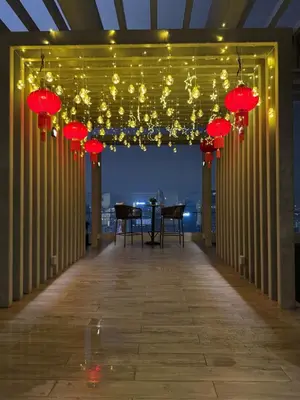 a hallway with red lanterns and a table with chairs at KLCC View Suites By Agile in Kuala Lumpur